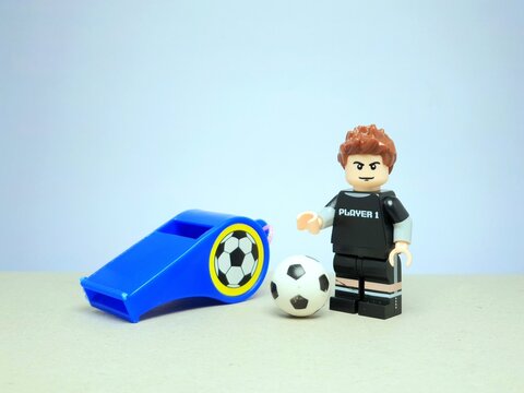 Indonesia - March 20, 2024 : Mini toy of action figure at table with blurred background. Toy photography concept. Football player concept design.