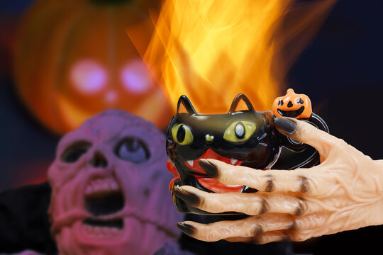 A withered demonic hand holding a drink evokes the atmosphere of a Halloween celebration.