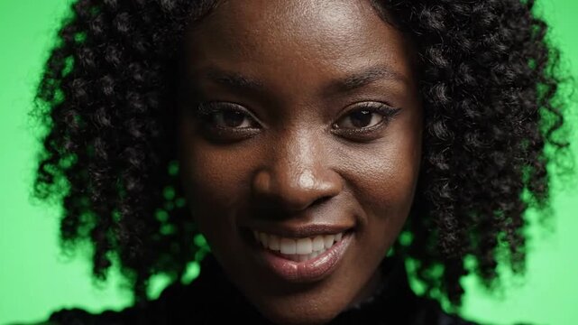 Smiling Woman with Curly Hair on Green Screen Background. 4K Video