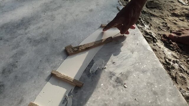 Worker Applying Adhesive Glue Paste On Marble Slab Surface For Tile Construction Work
