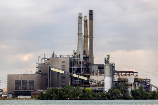 Large Industrial Power Plant and Smokestacks Along Waterfront