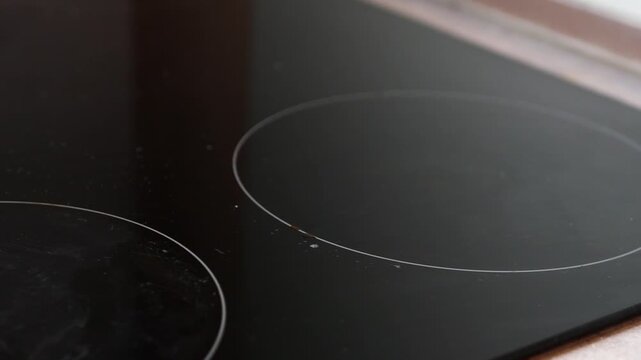 Close up on a modern induction stove top with circular heating elements for cooking food