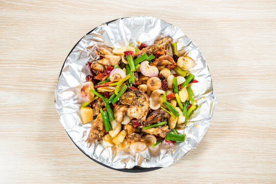 Spicy chicken stir fry on foil platter