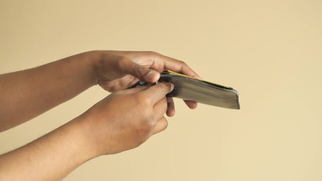 Person showing empty wallet with few cards inside, closeup on hands and money holder
