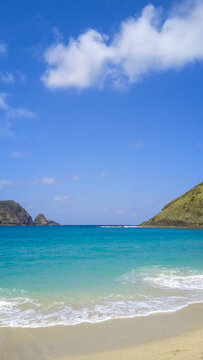 Turquoise Tropical Beach with Hills in Indonesia`