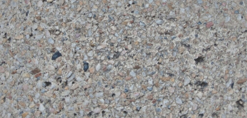 Exposed aggregate concrete texture, rough pebble dash surface with small stones, industrial grey cement background for architectural design © Arbaz