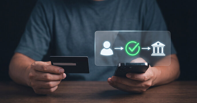 Person holding credit card and smartphone while using secure mobile banking application for financial transactions