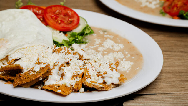 Mexican Chilaquiles with Fried Egg and Refried Beans