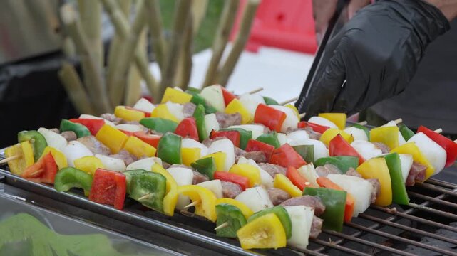 Colorful mixed vegetable skewers grilling over hot coals