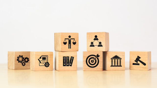 Wooden cube with ethics symbol. Represents corporate responsibility, integrity, and compliance in business practices.