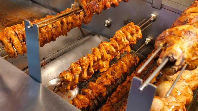 Grilled chicken and meat prepare in outdoor kitchen during local event