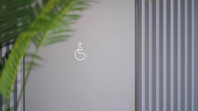 Sign for accessible restroom near entrance at a public building
