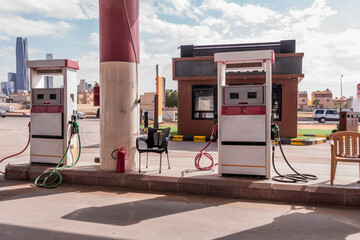 Fuel pumps at a Riyadh gas station with the King Abdullah Financial District skyline in Saudi Arabia.  © Artaxerxes