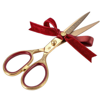 Vintage gold scissors with a red velvet ribbon isolated on white background