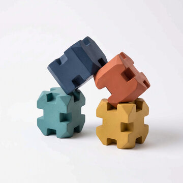 Studio Shot of Four Interlocking Colorful Concrete Tetrapod Blocks Stacked Together