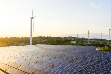 wind turbines and solar panels on hillside for green energy © zhangyang135769