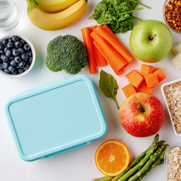 Healthy lunch box snack vegetable fruit blueberry broccoli carrot apple asparagus orange banana spinach oatmeal granola vitamin rich fiber packed fresh produce clean eating meal prep school office
