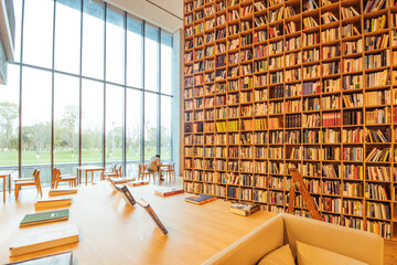 Contemporary Library with Floor-to-Ceiling Bookshelves and Natural Light © MaiVan