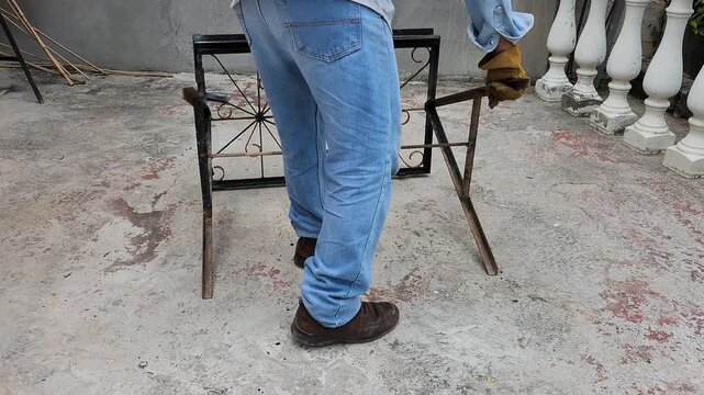 Blacksmith Lifting Custom Welded Workbench Made from Recycled Iron