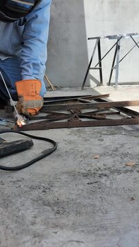 Welder Arc Welding Metal Joint as Iron Turns Glowing Red Hot