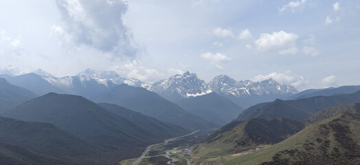 Snow Capped Mountain Range Above Winding River Valley Panorama © PhanThi
