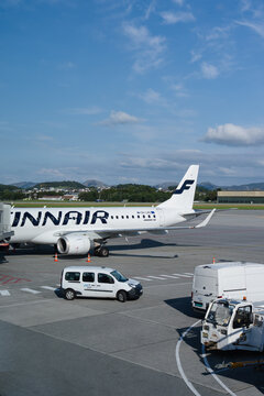 August 20, 2026, Stavanger, Norway - Finnair Embraer 190 aircraft parked at Stavanger Airport with ground support vehicles