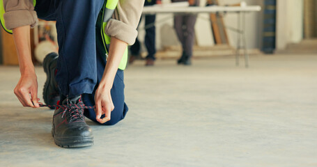 Person, architect and tying with boots in construction for building safety or security on space....