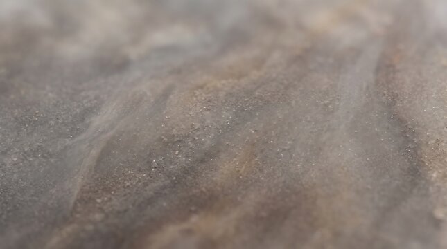 Macro view of a textured grey mineral stone surface with soft atmospheric lighting