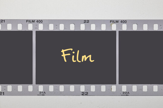 Horizontal 35mm film strip template with three blank dark frames on white background.