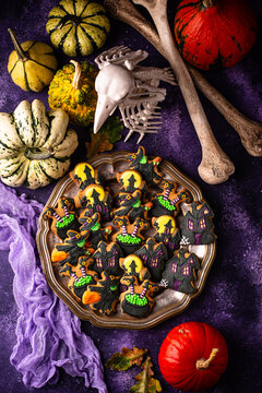 Spooky Halloween cookies shaped like witch cauldron and haunted manor