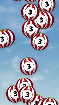Red and White Striped Numbered Balls Floating Over Blue Sky