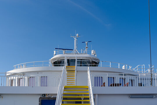 Modern white ferry bridge and upper deck against a clear blue sky in Norway