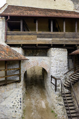 Fototapeta premium A view of the stone archway and wooden walkways of a medieval fortress.