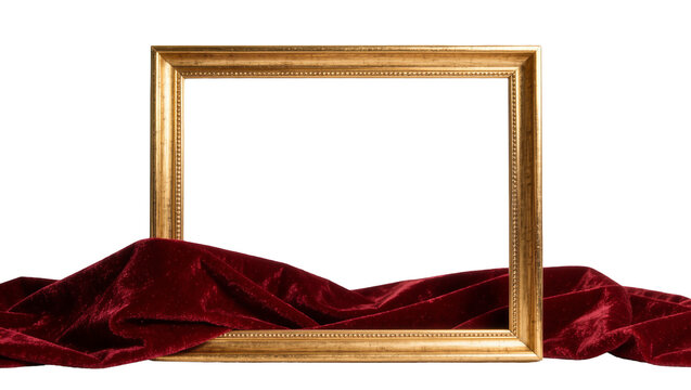Ornate golden picture frame resting on rich red velvet fabric, isolated on transparent background