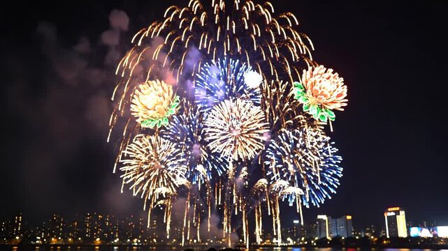 Colorful fireworks exploding over city skyline at night