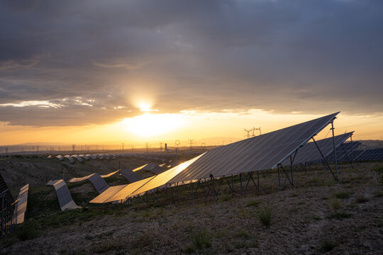 solar power plant with photovoltaic panels at sunset