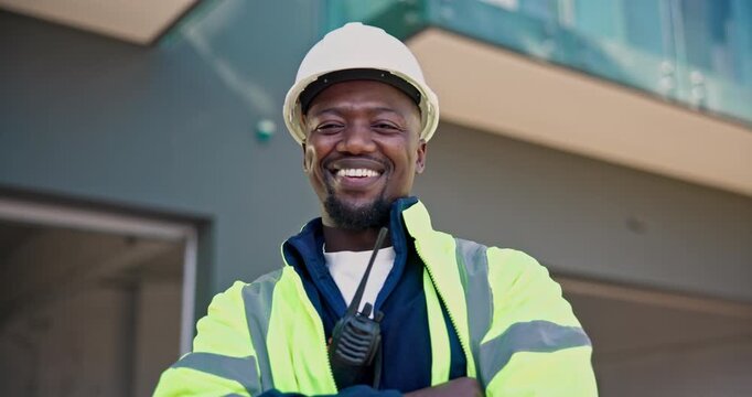 Engineer, face and happy man with arms crossed, construction site and confident with career growth. Civil engineering, portrait and black person with helmet, low angle or laugh for renovation project