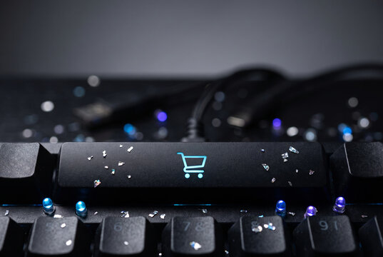 Glowing shopping cart key on modern mechanical computer keyboard