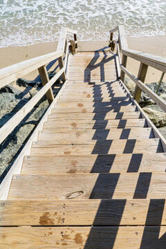 Wooden steps down to the sea, with fading wet foot prints, Busselton, Western Australia