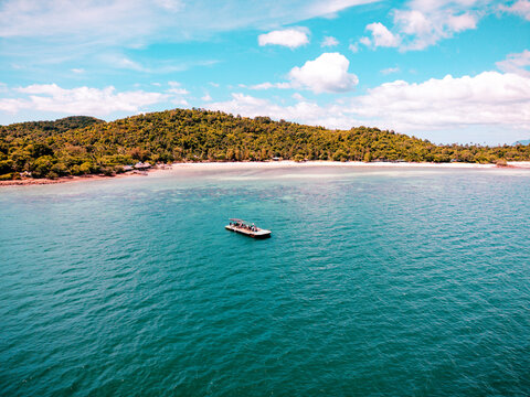 View of the beach and coastline of remote island along with underwater natural hard coral and reef