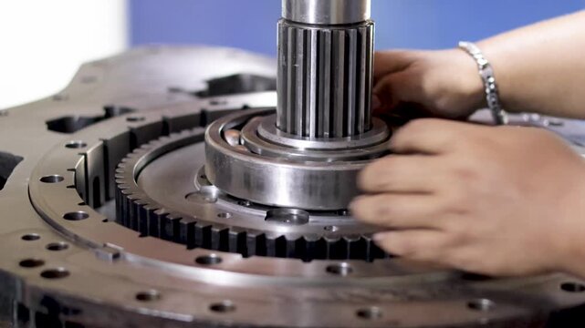 Heavy machinery splined shaft and ball bearing assembly in mechanical workshop.