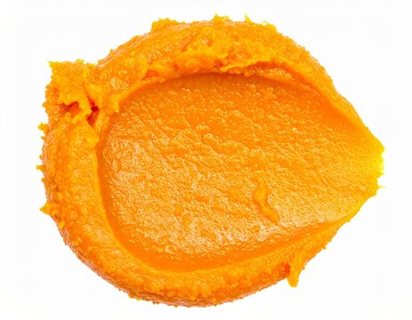 Fresh pumpkin puree spread on clean white background
