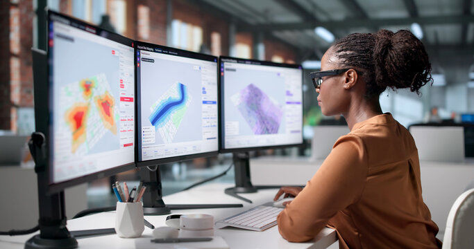 Geospatial Analyst Studies Flood Risk Maps On Computer