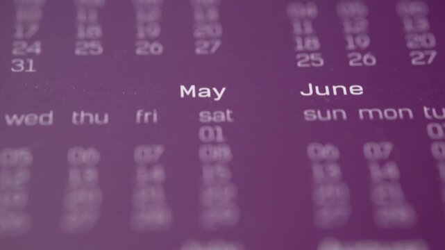 Camera panning across purple monthly calendar pages showing dates from march to december