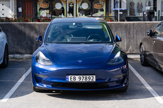August 19, 2026, Haugesund, Norway - Blue Tesla Model 3 electric car parked in a parking lot
