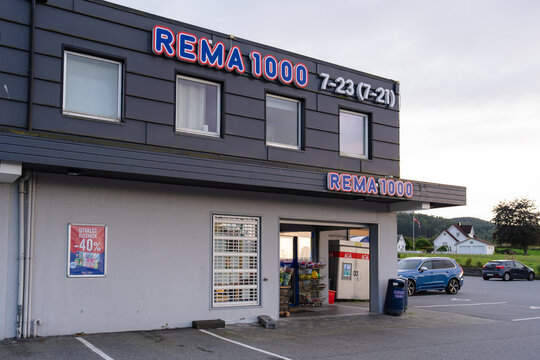 August 19, 2026, Fitjar, Norway - Exterior view of a REMA 1000 supermarket with a parking lot and cars.