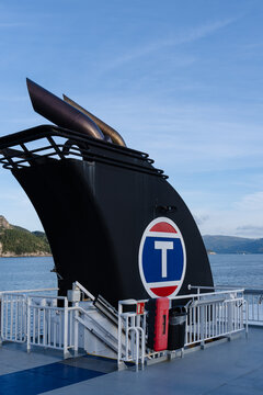 August 19, 2026, Halhjem, Norway - Funnel of a Torghatten Nord ferry with 'T' logo on a fjord
