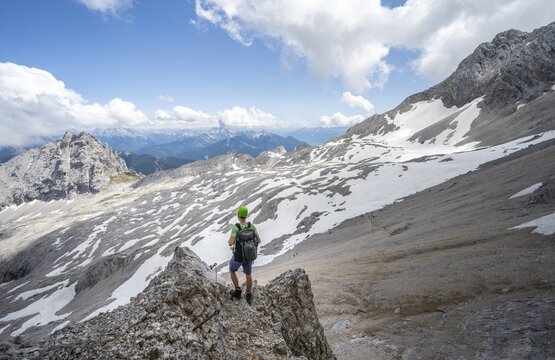 Hikers on the Hermann von Barth trail, via ferrata to the Partenkirchner Dreitorspitze, view of the Leutascher Platt with peak &Ouml;felekopf, Wetterstein range, Bavaria, Germany