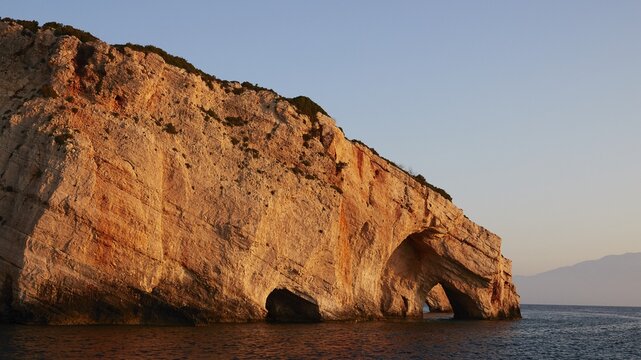 Blue Caves, morning light, rocky coast, blue cloudless sky, northeast coast, Zakynthos Island, Ionian Islands, Greece