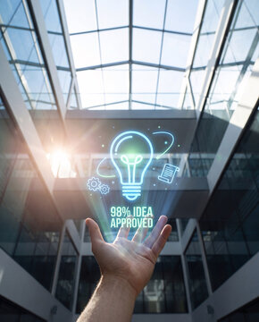 professional raises hand toward glowing idea approved hologram with lightbulb and gear icons in bright atrium, confirm innovation proposal accepted, track corporate research development